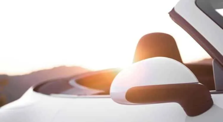 White convertible Porsche 911 4S at sunset in Saint Tropez.