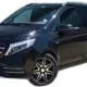 Hire a mercedes V Class, a black van parked in front of a white wall