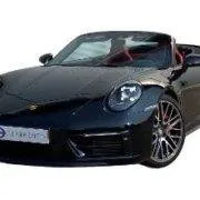 rent a porsche 992 cabriolet Black Porsche 992 Cabriolet with red leather interior and sleek design.